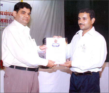 Bablu Kumar Deepak (right) receives an award from the divisional railways manager.