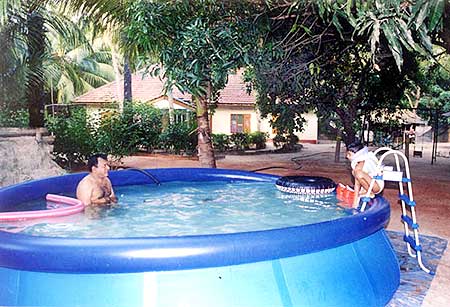 Prabhakaran swimming in a pool with his son Balachandran