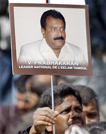 A protester waves a poster of LTTE leader Prabhakaran during a demonstration in support of the Tigers in Paris