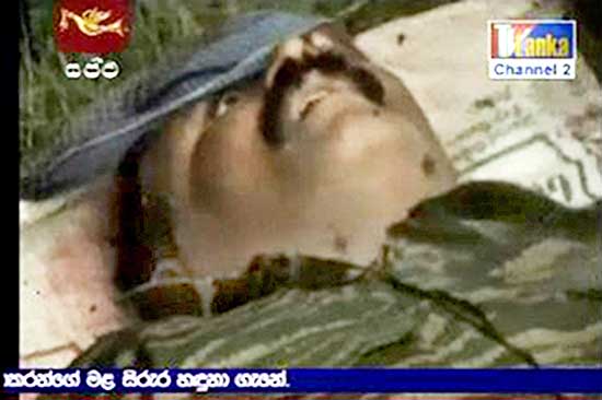 Sri Lankan TV stations aired video of what appeared to be LTTE chief's corpse, with the top of its head blown off