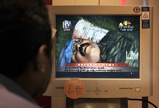 A journalist looks at footage from Sri Lankan internet television