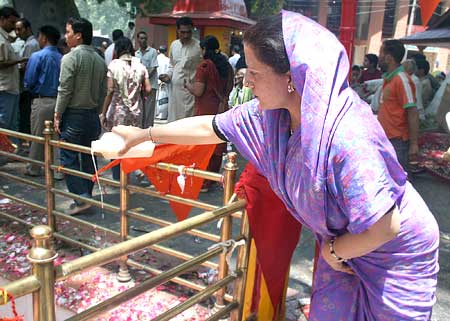 A devotee offers milk at the temple