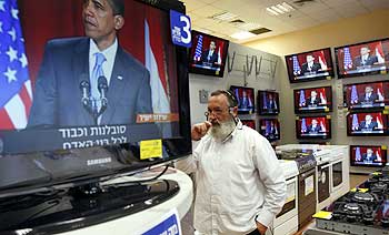 An Israeli salesperson in Tel Aviv listens to US President Barack Obama's Cairo speech