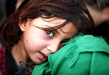 Rabiya, fleeing an offensive in South Waziristan, waits with her father at a refugee camp.