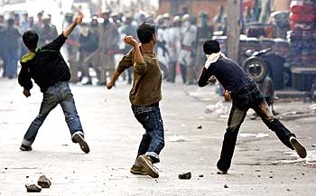 Kashmiri protesters throw stones and bricks at policemen during a demonstration.