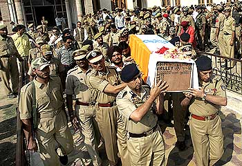 Senior police officers carry the coffin of one of their colleagues during the wreath-laying ceremony in Srinagar.