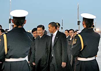 US President Barack Obama and Chinese Vice President Xi Jinping walk past an honour guard after Obama's arrival in Beijing
