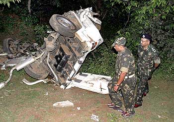 Police officers at the site of a landmine explosion in Pundgiri, Jharkhand, June 30, 2008.