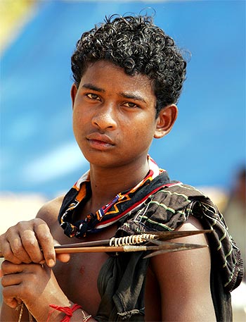 A boy holds a bow and arrow at a relief camp in Dharbaguda, in Chhattisgarh, where violence has mounted since the state government started funding an anti-Maoist movement
