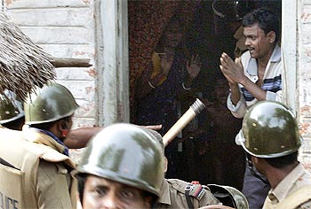 A villager begs a policeman to spare him from being arrested at Pirakata near Lalgarh, West Bengal, June 18, 2009