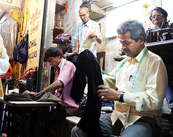 Vasant Gohil in his open air tailoring stall next to Leopold Cafe.