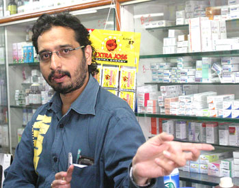 Bharat Waghela at his medicine store. He lost his brother in the shootout.