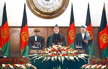 Afghanistan President Hamid Karzai is flanked by his vice presidents Mohammad Qasim Fahim (Left) and Karim Khalili as he takes oath during his inauguration as President in Kabul