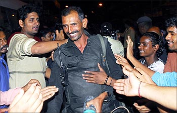 Mumbai residents congratulate an NSG commando after the operation was completed