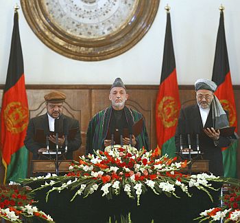 Afghan President Hamid Karzai flanked by Vice-Presidents Mohammad Qasim Fahim, left, Karim Khalili