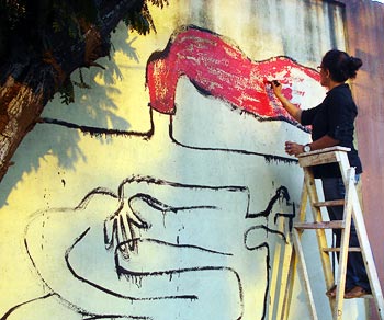 A participant paints the wall in tribute