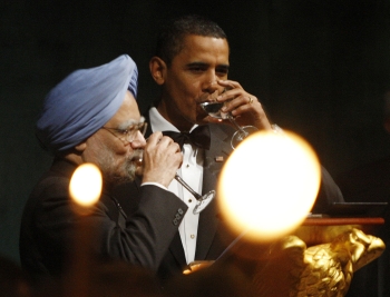 US President Barack Obama and Prime Minister Manmohan Singh drink a toast among candlelight during a State Dinner in a giant tent on the South Lawn of the White House