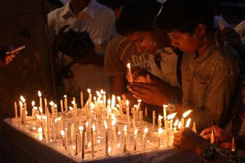 Children lighting candles outside Chabad house