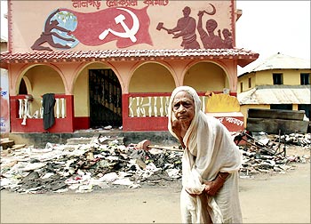 A woman outside a CPI-M office, wrecked by the Maoists in Lalgarh, Bengal