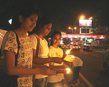 Children light up candles in memory