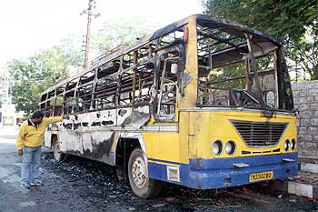 Charred remains of a bus set ablaze by an unruly mob