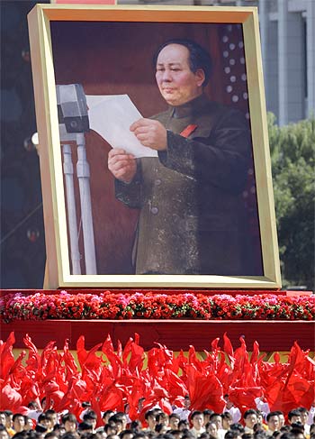 Participants hold a portrait of China's late Chairman Mao Zedong during the parade