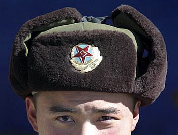 A Chinese soldier poses for a photograph