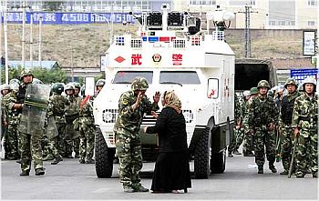 A woman argues with a soldier in Urumqi, China's troubled Xinjiang province