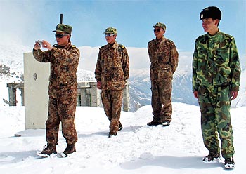A Chinese soldier takes photographs at Nathu La in Sikkim in 2005.