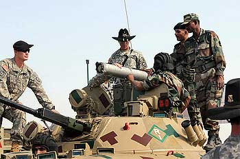 Indian Army soldiers and the American 14th Cavalry Regiment share information about vehicles and weapons systems