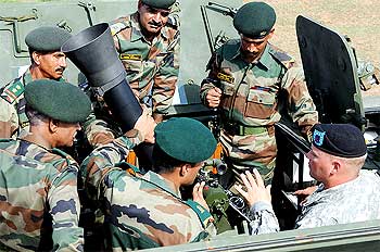 US soldiers share information on the stryker's mortar system with Indian soldiers