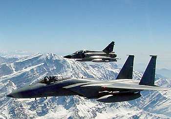 An F-15 Eagle and a Mirage 2000 fly together over the Himalayas during a wargame