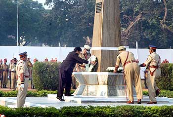 Maharashtra Chief Minister Ashok Chavan pay respect at a memorial along with state DGP SS Virk