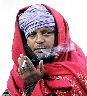 A man smoking a bidi.