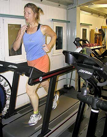 A woman runs on the treadmill