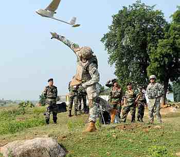 A US soldier tosses an unmanned aerial vehicle as Indian soldiers look on. The soldier, Spc David Swan, is an infantryman assigned to Troop B, 2nd Squadron, 14th Cavalry Regiment, Strykehorse, 2nd Stryker Brigade Combat Team, 25th Infantry Division