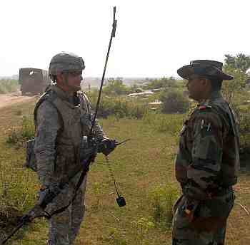 Army Col LP Singh, commanding officer of the 7th Mechanised Battalion, addresses US Army Cpt Digati, troop commander, Troop B, 2nd Squadron, 14th Cavalry Regiment Strykehorse, 2nd Stryker Brigade Combat Team, 25th Infantry Division, from Schofield Barracks, Hawaii, at the end of the first overnight operation