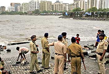 Policemen stand guard at the site off the Arabian Sea in south Mumbai where the terrorists are said to have landed on 26/11