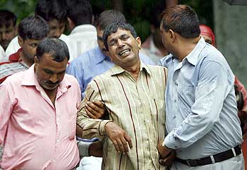 Nawab Singh Nagar (centre), Lalita's father, is consoled by relatives