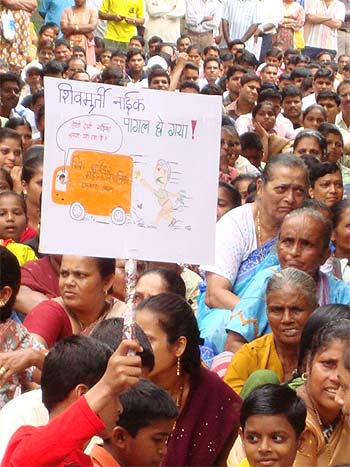 A protestor holds a placard against Mira-Bhayander Municipal Commissioner Shiv Murti Naik