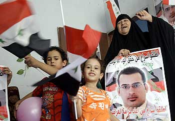 Relatives of the Iraqi reporter Muntazer al-Zaidi celebrate at his house