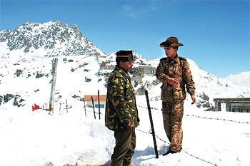 An Indian army officer talks with a Chinese soldier at the 4,310 metre high Nathu-la pass on the country's northeastern border with China