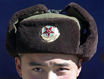 A Chinese soldier looks into the camera at the India-China trade route at Nathu-La, 55 north of Gangtok, capital of Sikkim