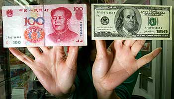 A Chinese renimbi 100 banknote, left, and a US$100 banknote