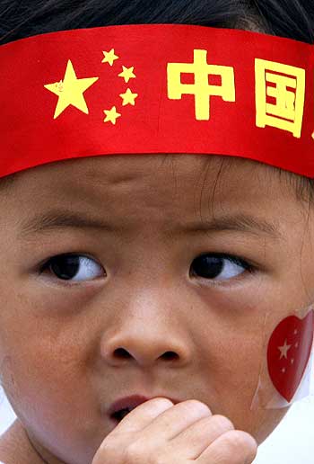 A boy with a Go China headband in Tiananmen Square