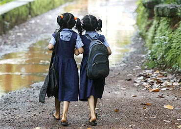 Two girls walk to their school in a Kerala village