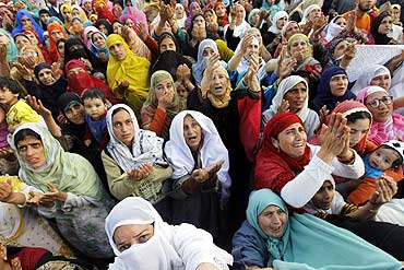 Kashmiri women attend a religious ceremony in Srinagar