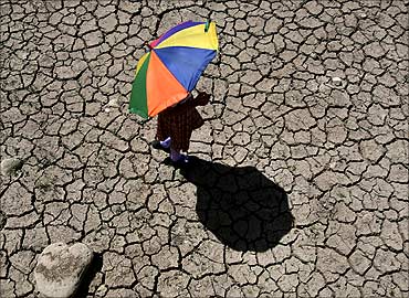 A schoolgirl crosses a dry pond on the outskirts of Jammu