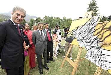 Pakistan's Foreign Minister Qureshi and his Indian counterpart SM Krishna attend an open art exhibition by SAARC artists themed 'Towards a Green and Happy South Asia' in Thimphu on Tuesday