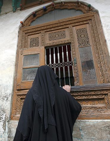 A Kashmiri woman prays at the Rozabal shrine in Srinagar. A decades-old theory that Jesus survived the crucifixion and spent his remaining years in Kashmir had drawn many people to Rozabal, a single-storey shrine with a traditional sloping roof located in a congested residential area of the capital Srinagar